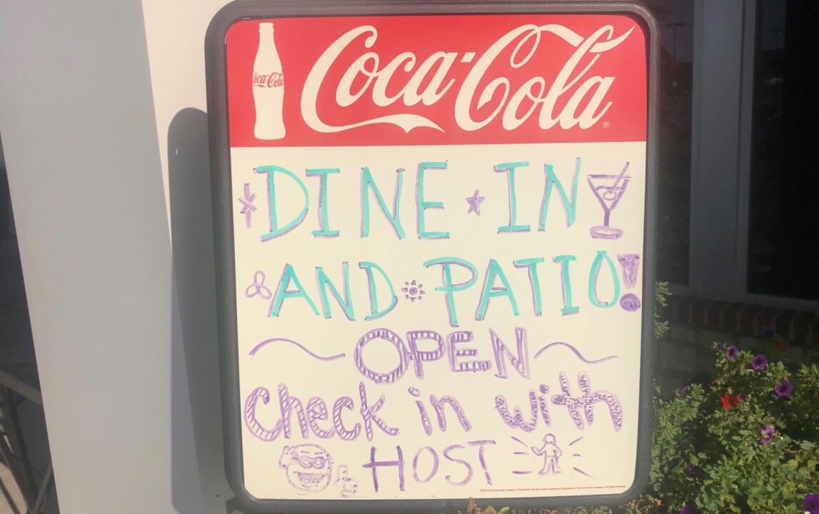 A restaurant sign that says Patio Open